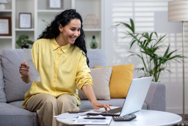Smiling young beautiful woman working on laptop